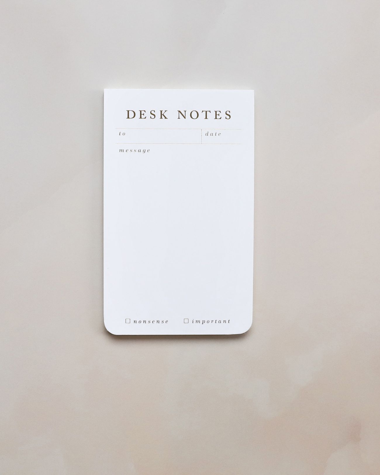A desk notes pad on soft blush marble